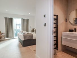 A bedroom with a bed and bathroom area at 13 Cliff Edge in Newquay