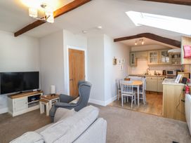 A living room with a sofa and television in Ash Cottage, Combe Martin