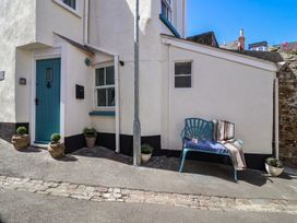 An outdoor area with a blue door and a bench at Honeymoon Cottage Appledore