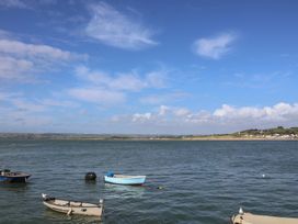 A view of boats on water under a cloudy sky at Honeymoon Cottage in Appledore