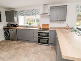 A kitchen with cabinets, sink, oven and dishwasher at Whinney Moor