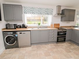 A kitchen with appliances and cabinets at Whinney Moor in 