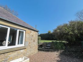 A view of a garden with steps and a stone wall at Whinney Moor