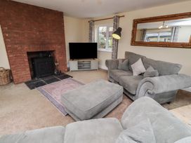 A living room with a sofa and television at Whinney Moor in Alnwick
