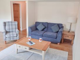 A living room with a sofa and armchair at Bugle in Saltburn-By-The-Sea
