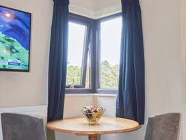 A kitchen with a table and a fruit bowl at Bugle Saltburn-By-The-Sea