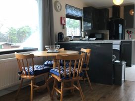 A kitchen with a table and chairs at Bugle Saltburn-By-The-Sea