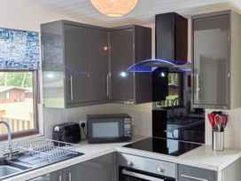 A kitchen with a microwave and cooking utensils at Bugle in Saltburn-By-The-Sea