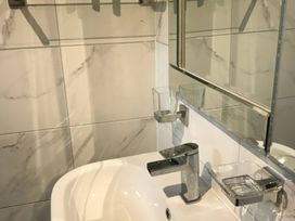 A bathroom with a sink and wall-mounted accessories at Bugle Saltburn-By-The-Sea
