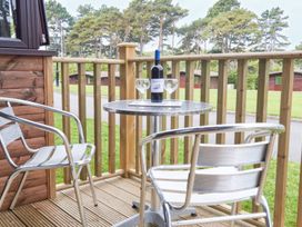 A table with a wine bottle and glasses on a balcony at Bugle Saltburn-By-The-Sea