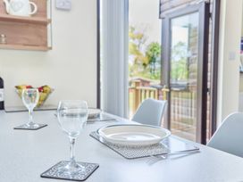 A dining table set with glasses and plates at Lavender Lodge in Saltburn-By-The-Sea