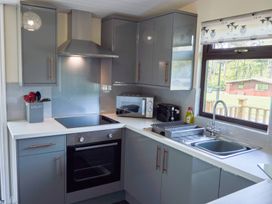 A kitchen with a sink, stove, oven, and window at Lavender Lodge in Saltburn-By-The-Sea