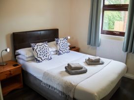 A bedroom with a double bed and bedside tables at Lavender Lodge in Saltburn-By-The-Sea