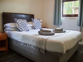 A bedroom with a double bed and pillows at Lavender Lodge in Saltburn-By-The-Sea