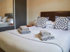A bedroom with a bed and towels at Lavender Lodge in Saltburn-By-The-Sea