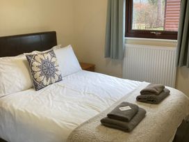 A bedroom with a bed and towels at Lavender Lodge in Saltburn-By-The-Sea