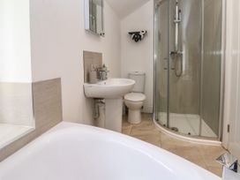 A bathroom with a bathtub sink toilet and shower enclosure at Cae Iocyn in Chirk