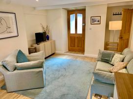 A living room with a sofa and television at Bobbin Cottage in Swanage