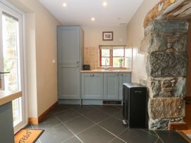 A kitchen featuring a sink and cabinets at Beudy Penarddwnion Rhydymain near Dolgellau