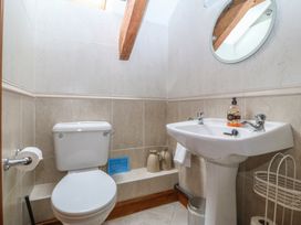 A bathroom with a sink and toilet at Beudy Penarddwnion Rhydymain near Dolgellau