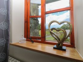 A window with a heart sculpture on the sill at Beudy Penarddwnion Rhydymain near Dolgellau