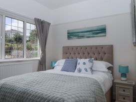 A bedroom with a bed and bedside table at Kinbrae Apartment in Torquay