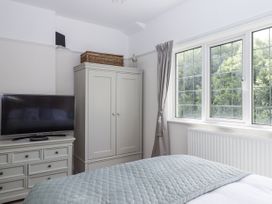 A bedroom with a television and wardrobe at Kinbrae Apartment in Torquay