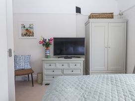 A bedroom with a bed and television at Kinbrae Apartment in Torquay