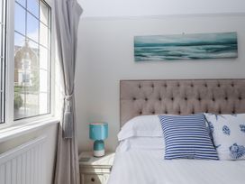 A bedroom with a bed and window at Kinbrae Apartment in Torquay
