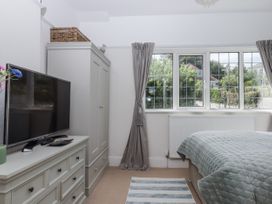 A bedroom with a television and dresser at Kinbrae Apartment in Torquay