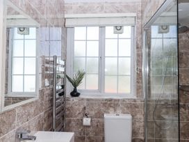 A bathroom with a shower and toilet at Kinbrae Apartment in Torquay