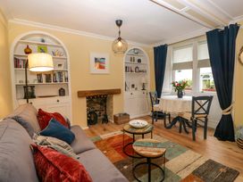 A living room with a sofa, table and chairs at 1 Tower House in Cartmel