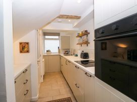 A kitchen with appliances and storage at 1 Tower House in Cartmel