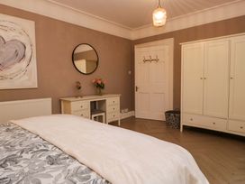 A bedroom with a bed and wardrobe at 1 Tower House in Cartmel