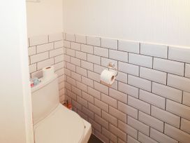 A small bathroom with a toilet roll holder and a toilet at 11 Magdalene Road Torquay