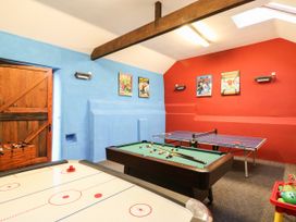 A games room with a pool table air hockey table ping pong table and foosball table at Beechcroft Cottage in North Molton