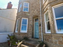 A front entrance with a blue door and windows at Heron in St Ives