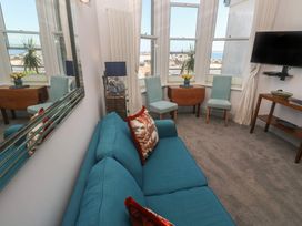 A living room with a sofa and chairs at Heron in St Ives