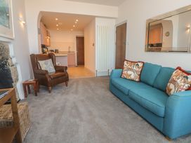 A living room with a sofa and armchair at Heron in St Ives