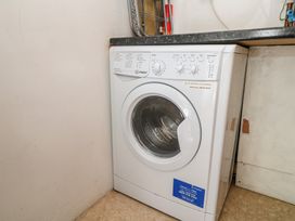 A washing machine in a laundry room at Heron St Ives