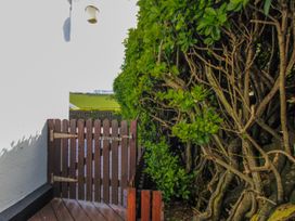 A wooden gate and greenery outside Eddystone in Hope Cove