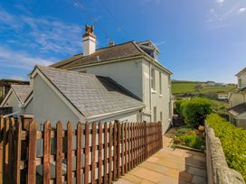 A side view of a house with a pathway and garden at Eddystone in Hope Cove