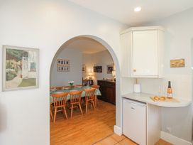 A kitchen with a dining area and appliances at Eddystone in Hope Cove