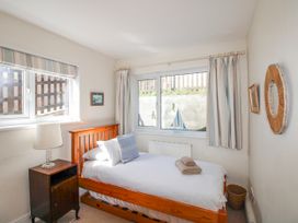 A bedroom with a single bed and window at Eddystone in Hope Cove