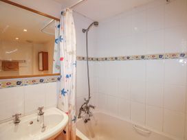 A bathroom with a bathtub and sink at Eddystone in Hope Cove