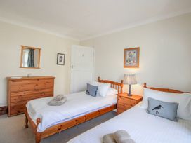 A bedroom with two single beds and a dresser at Eddystone in Hope Cove