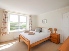 A bedroom with a bed and a bedside table at Eddystone in Hope Cove