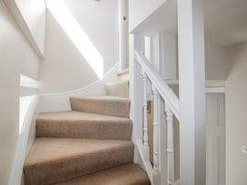 A staircase with carpet and railing at Eddystone in Hope Cove
