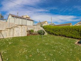 A garden with grass and steps at Eddystone in Hope Cove