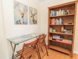 A study room with a table and bookshelf at White Stones, Fulbrook, near Burford